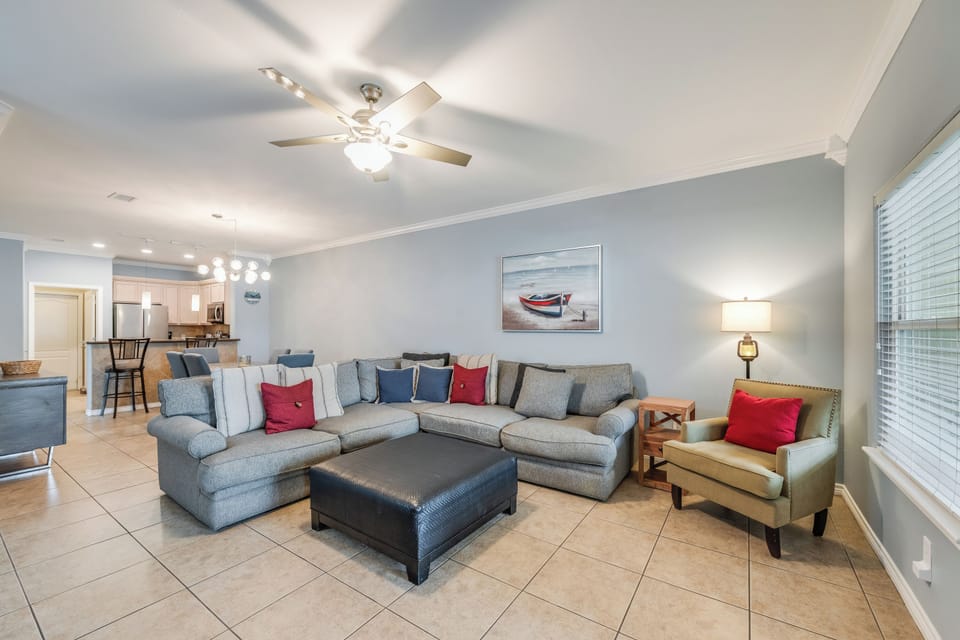 Relax in your spacious living room with plush sectional seating, perfect for gathering with loved ones after beach days.
