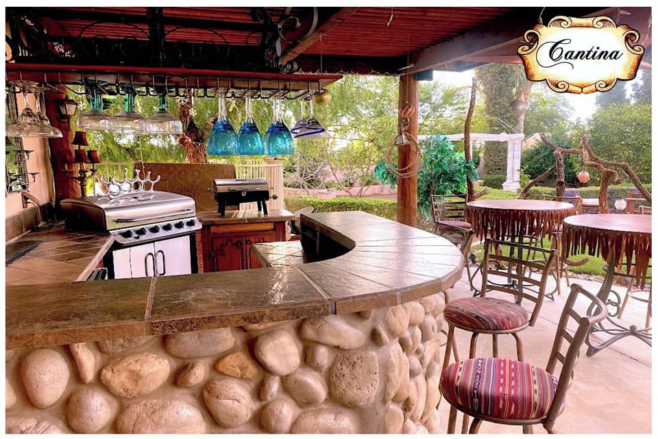 Outdoor Cantina with  bar & bistro table seating , BBQ, and Sports Bar TV