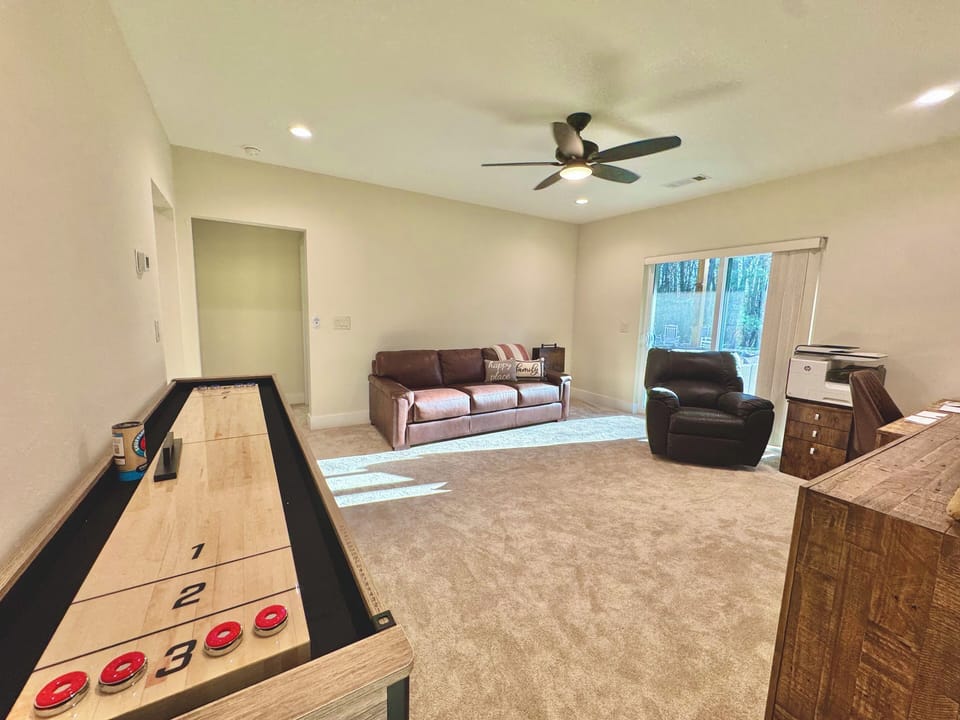 Lower Living Room With Shuffle Board and Games. Fold Out Couch