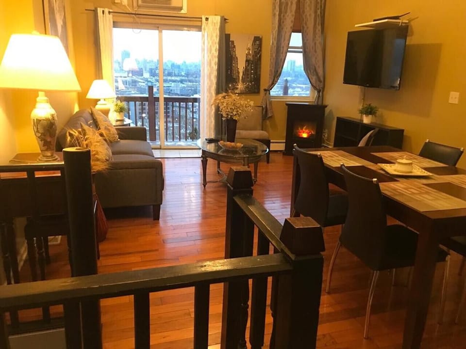 Living room area, fireplace, desk, full size, pullout sofa, TV, AC, ceiling fan.