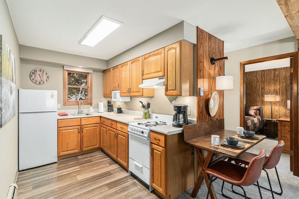 Enjoy the convenience of a full kitchen and a dining table with seating for four.