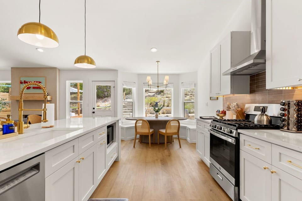 Bright, spacious kitchen with room for everyone to help cook or just hang out with coffee while pretending to help.