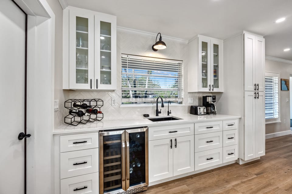 Coffee and wine bar with coffee station, sink and wine fridge.