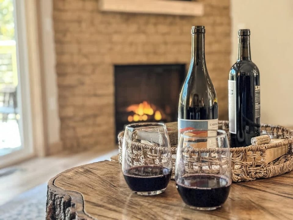 Living room features large sliding glass doors that lead to a deck in the tree tops. Turn the gas fire place on for a cozy winter day in. 