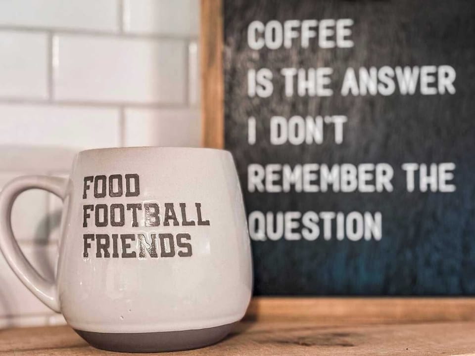 Sip and smile—this space features two decorative coffee sayings plaques that create a warm, inviting atmosphere. A perfect backdrop for your morning routine or a relaxing break during your stay.