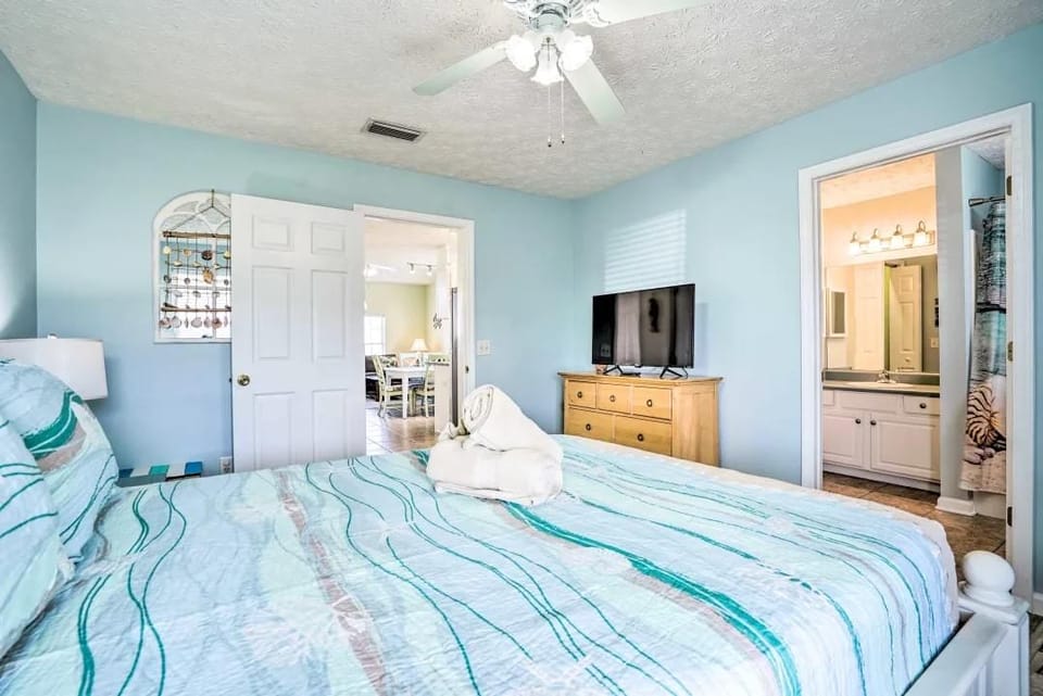 Master bedroom with queen bed and smart TV