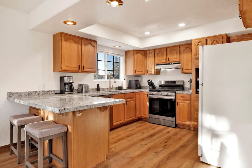 Large kitchen for cooking in with two bar stools
