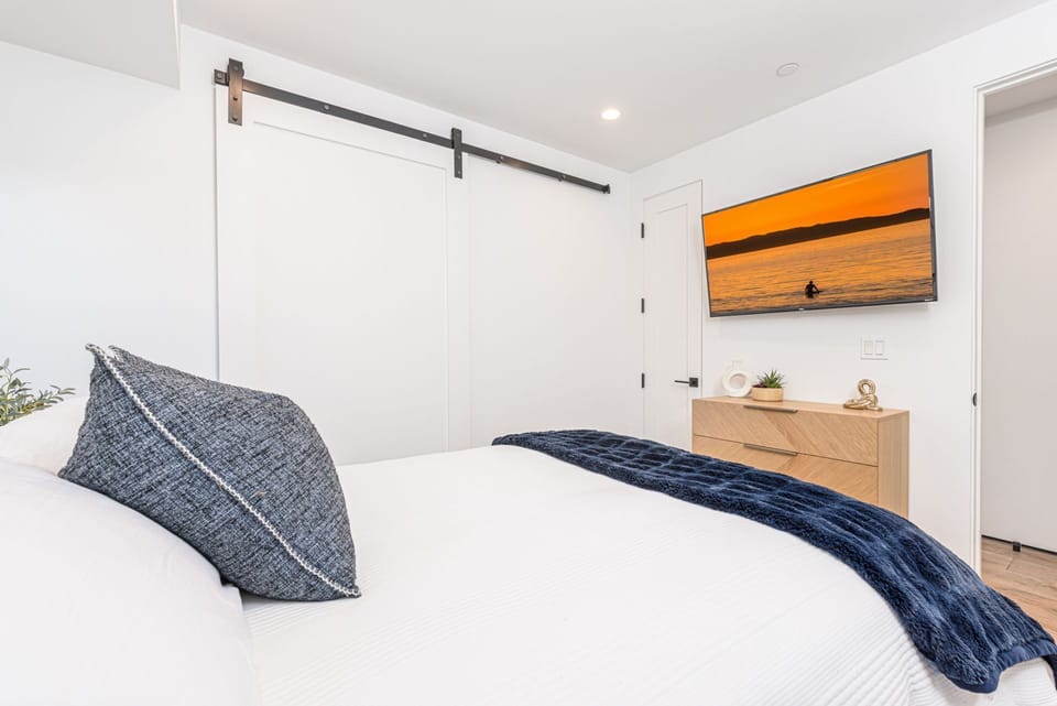 Unwind in comfort with your favorite show on the flat-screen TV, wrapped in cozy textures and serene surroundings
                