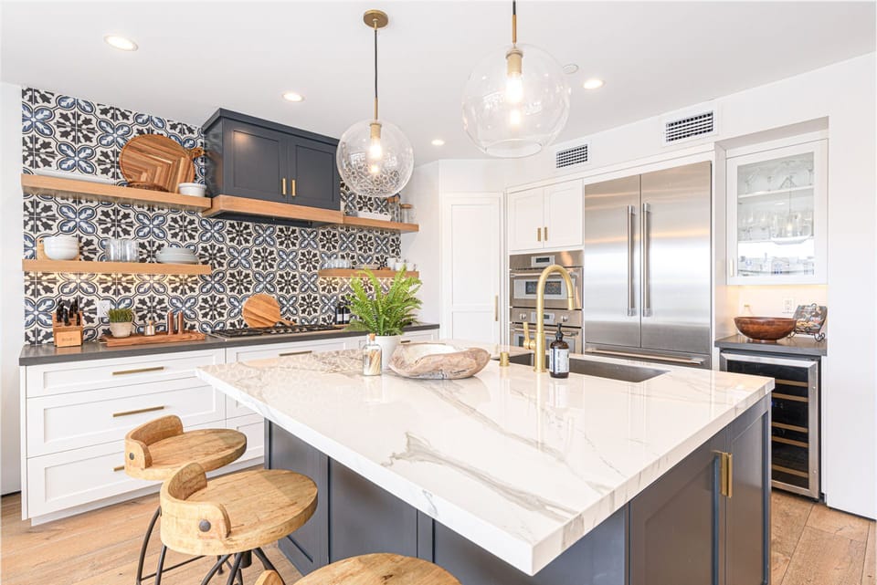 Gather around the expansive island for wine, conversation, and effortless entertaining
                