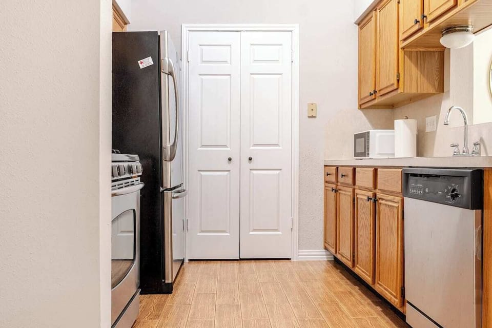 The warm wood cabinetry adds charm, while the modern appliances make it easy.