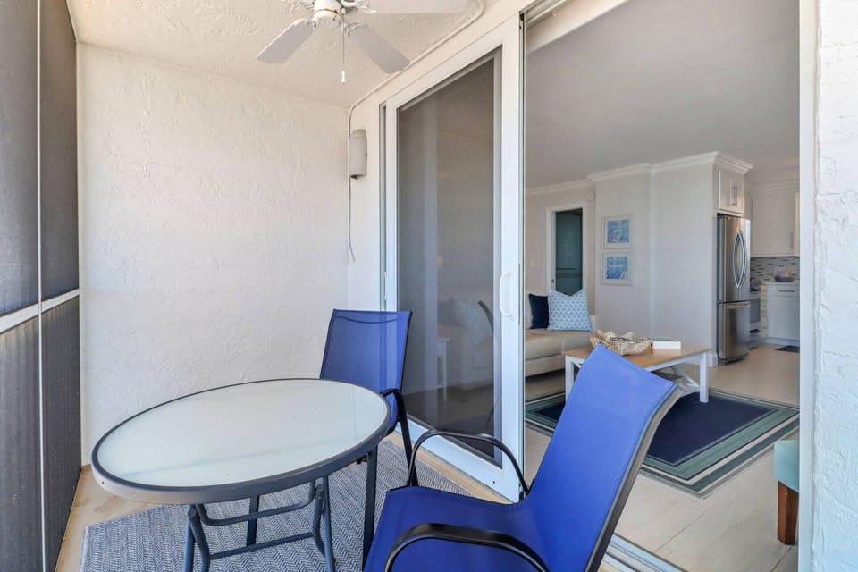 Sliding glass doors lead out to the fully screened, 10th floor balcony.