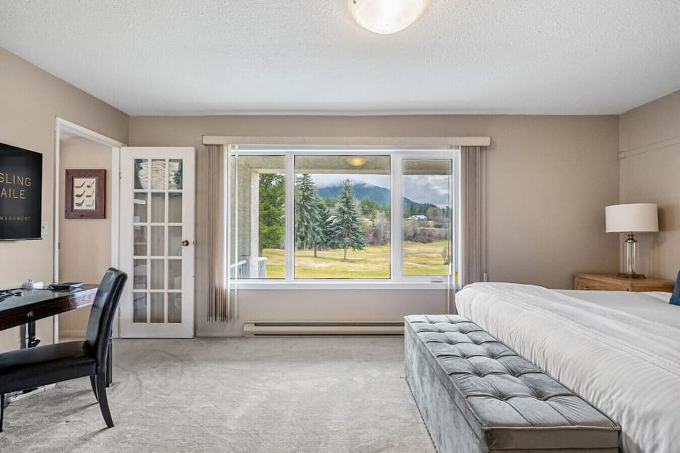 Primary bedroom with a king bed, mountain/golf course views, Smart TV with cable, dedicated workstation and a private ensuite full bath.