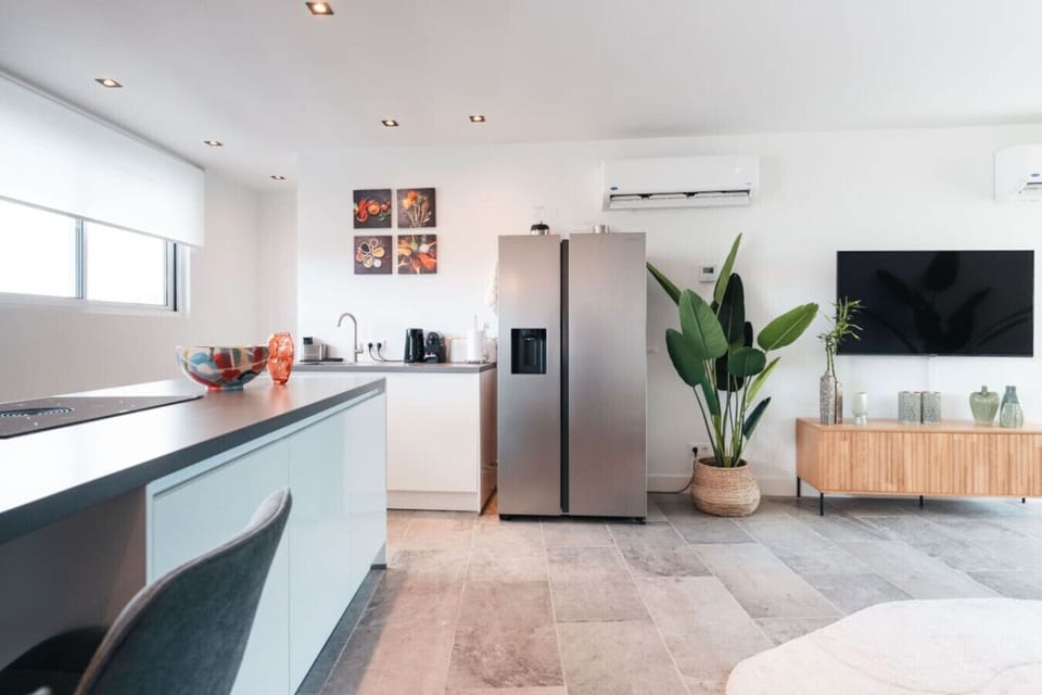 This space is perfect for whipping up your favorite meals or enjoying a cozy breakfast. With modern appliances, stylish decor, and a splash of greenery, you`ll feel right at home.