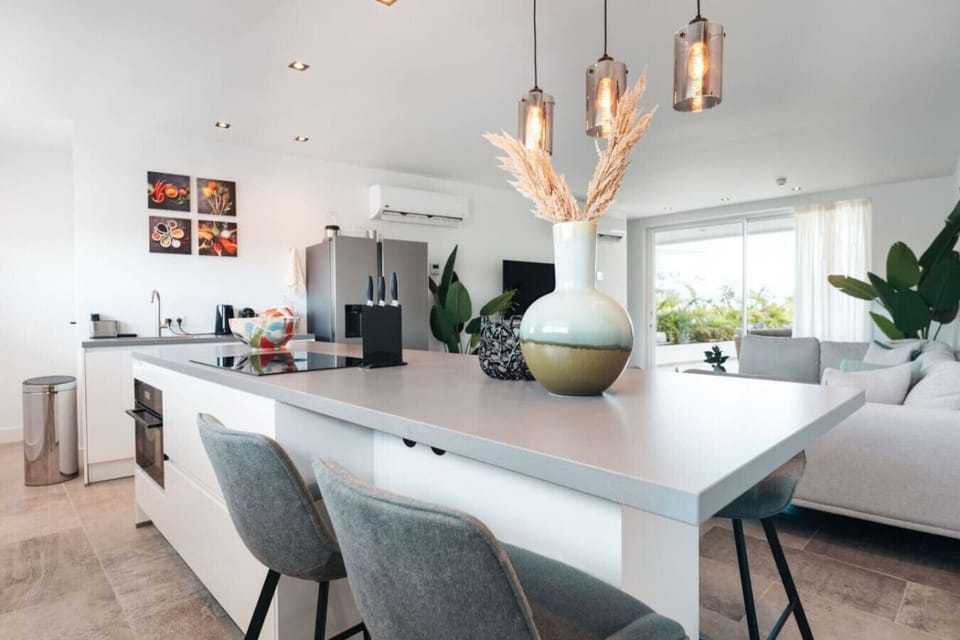 Welcome to your culinary haven! This modern kitchen is perfect for cooking and gathering. With a sleek island and cozy seating, it’s the ideal spot for meals and memories. Enjoy!