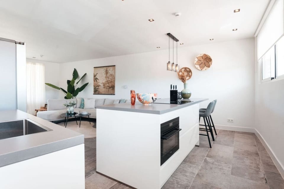 This open-concept living space features a sleek kitchen island for casual dining and a cozy seating area perfect for relaxing.