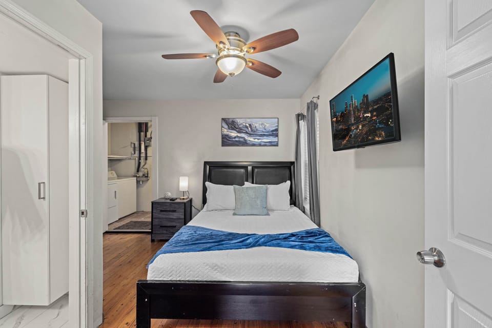 Bedroom with queen size bed! We include a smart TV and a full-length mirror.