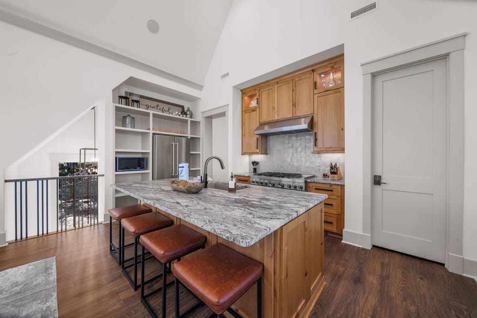 Additional Seating at the Kitchen Island Provides the Option to Dine Together with a Full House on Upper Level