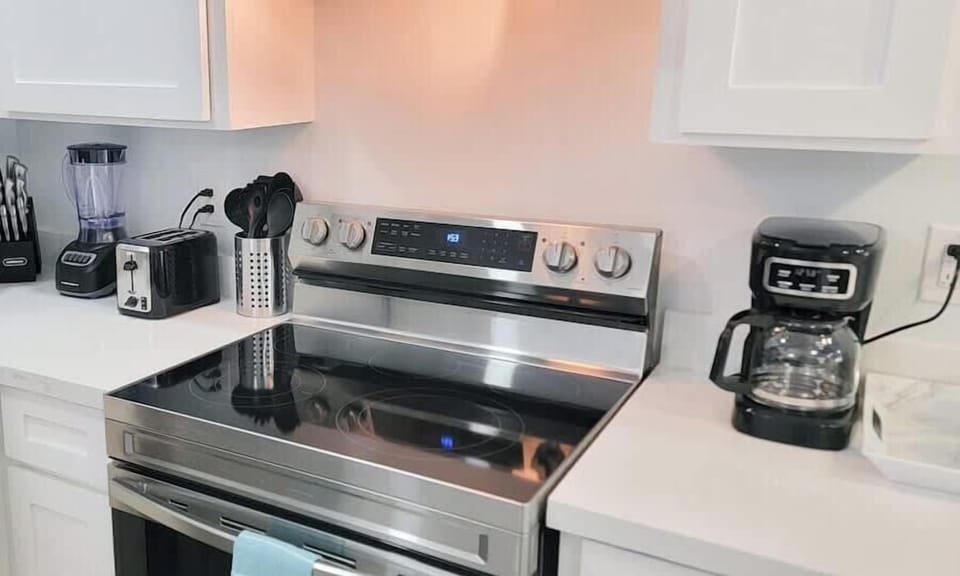 A well‑kept, inviting kitchen space with a clear, open feel that sets a steady tone. The organized layout and gentle lighting create a quiet sense of ease, offering a comfortable place to move through your day at a natural, relaxed rhythm.