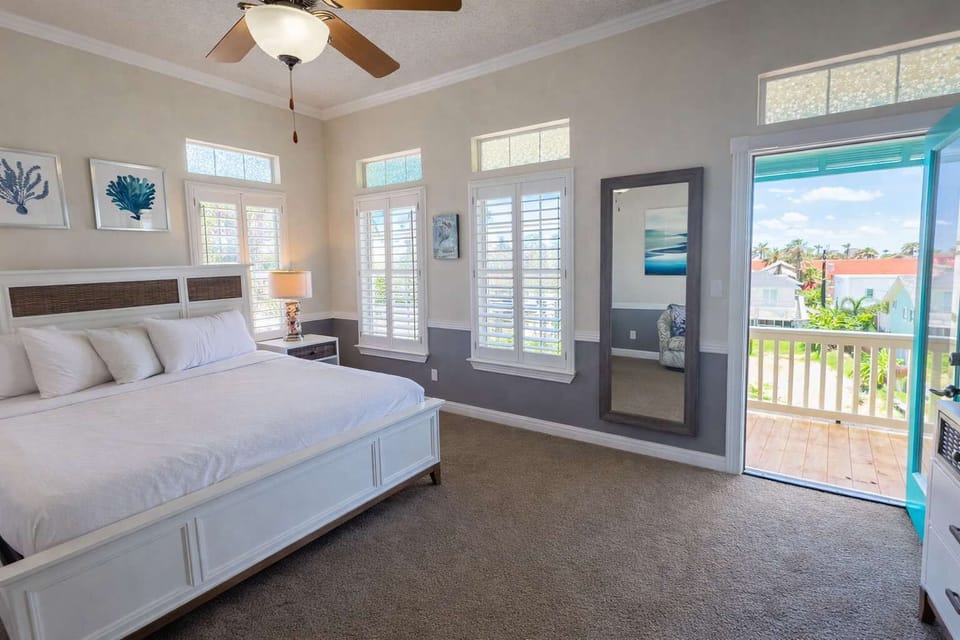 Step into a serene bedroom with coastal charm, sunlight and private balcony access. Enjoy plush bedding, stylish furnishings and refreshing outdoor views—a relaxing retreat just minutes from the sandy beaches of South Padre Island.