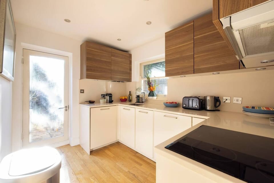 Escape to our private garden oasis, easily accessible through the kitchen. Step outside from the comfort of our well-equipped kitchen and immerse yourself in the beauty of nature. 