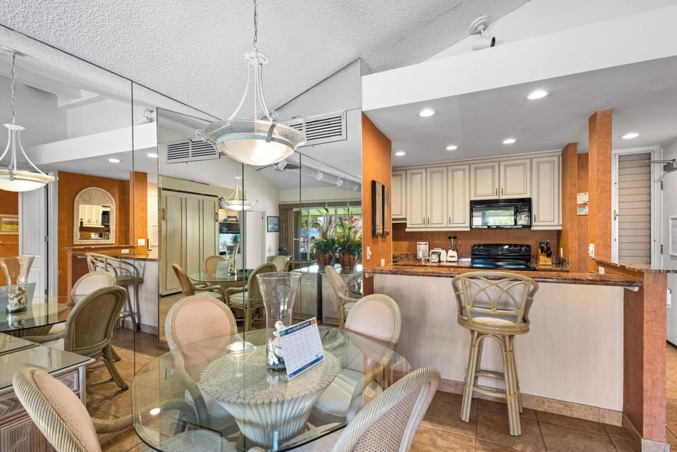 A bright, open-concept living space where the kitchen flows seamlessly into the dining area, perfect for gathering and enjoying meals together during your stay.
