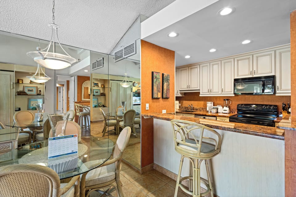 Stylish open-concept kitchen and dining area where you can cook, dine, and relax in bright, elegant coastal comfort with modern appliances and warm finishes.