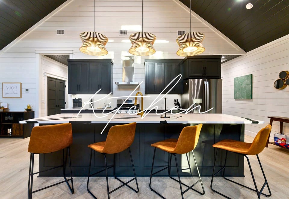 The large island is ideal for everything from pancake breakfasts to game-night snacks, with enough comfy barstools to seat the whole crew.