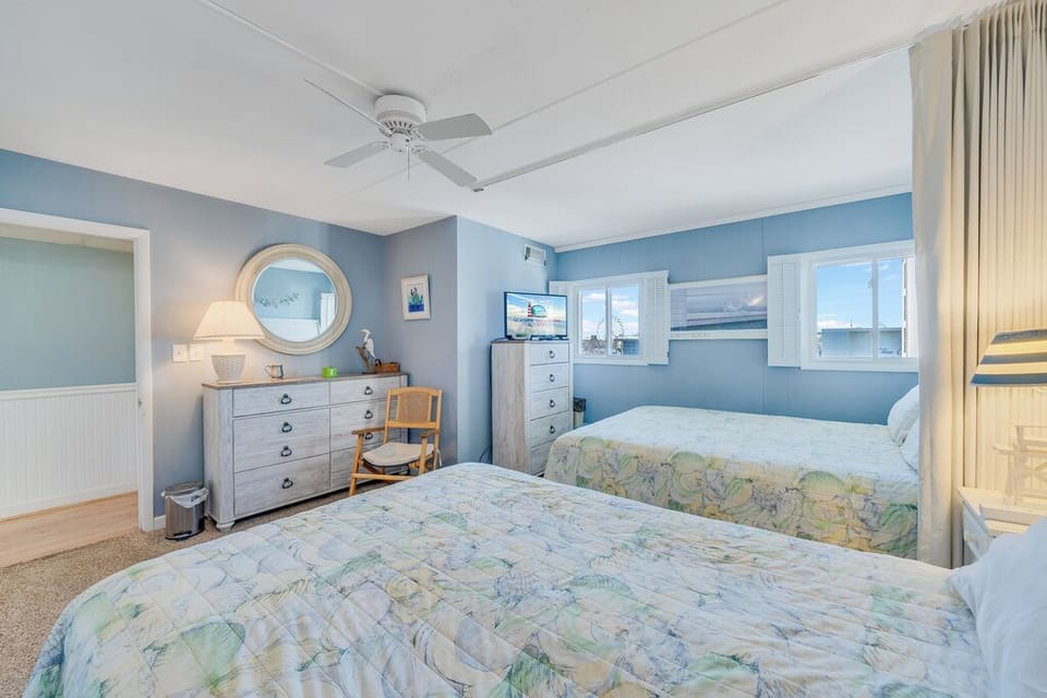 Sink into the Cozy Queen Beds & Relax after a long day of Fun in the Sun.