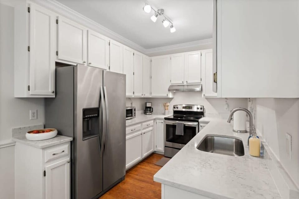 Spacious kitchen with contemporary finishes, stainless steel appliances, and plenty of counter space. Perfect for preparing meals and enjoying time together.