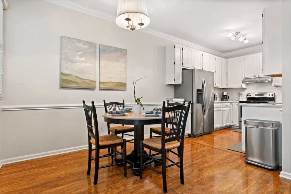 Inviting dining space featuring a contemporary table, comfortable chairs, and an open layout. The dining area flows seamlessly into the kitchen for a relaxed and social atmosphere.