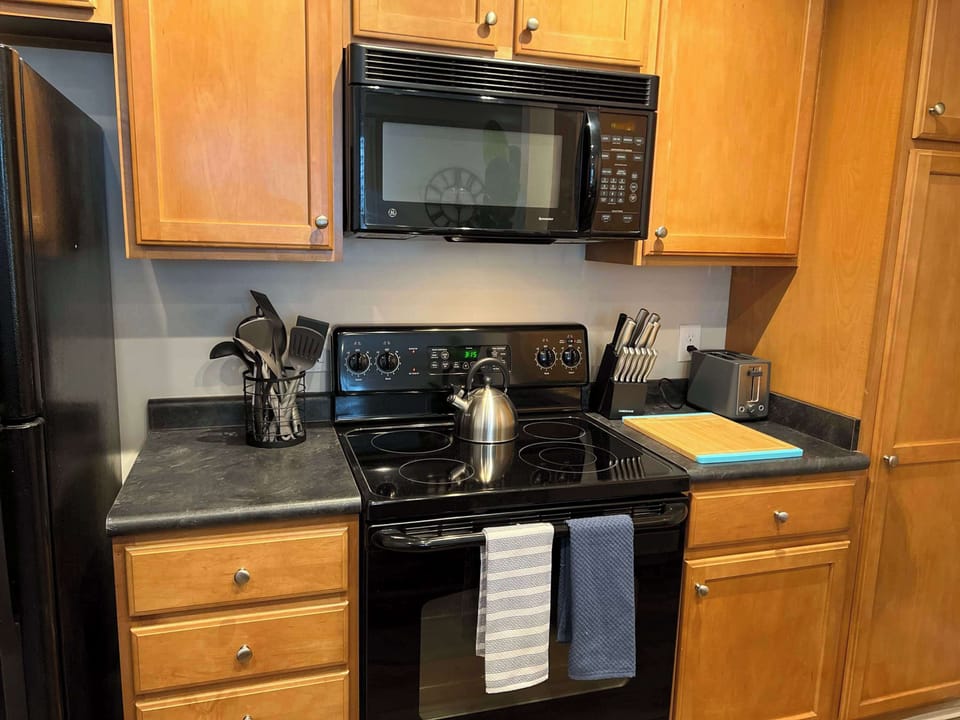 Well organized kitchen with modern appliances, warm cabinetry, and practical layout. A comfortable space for cooking, meal prep, and everyday use.