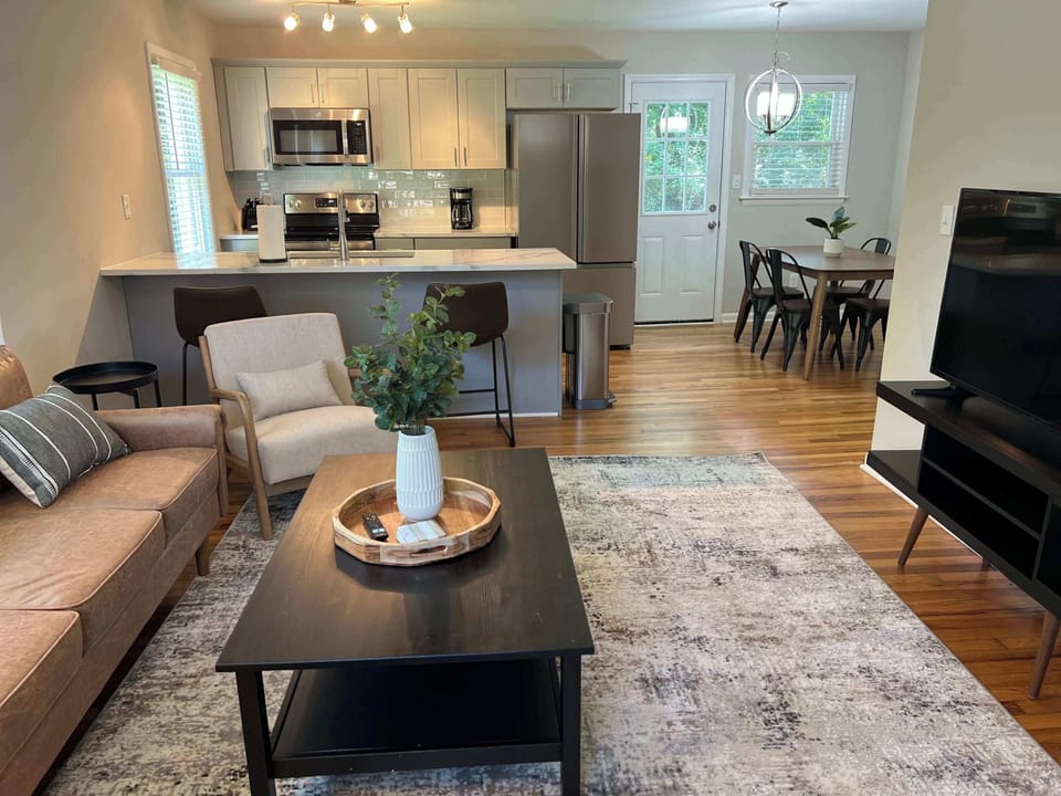 Spacious and thoughtfully designed living area with plush seating and modern touches. An open layout links the living room, kitchen, and dining space, making it ideal for gathering or unwinding in comfort.
