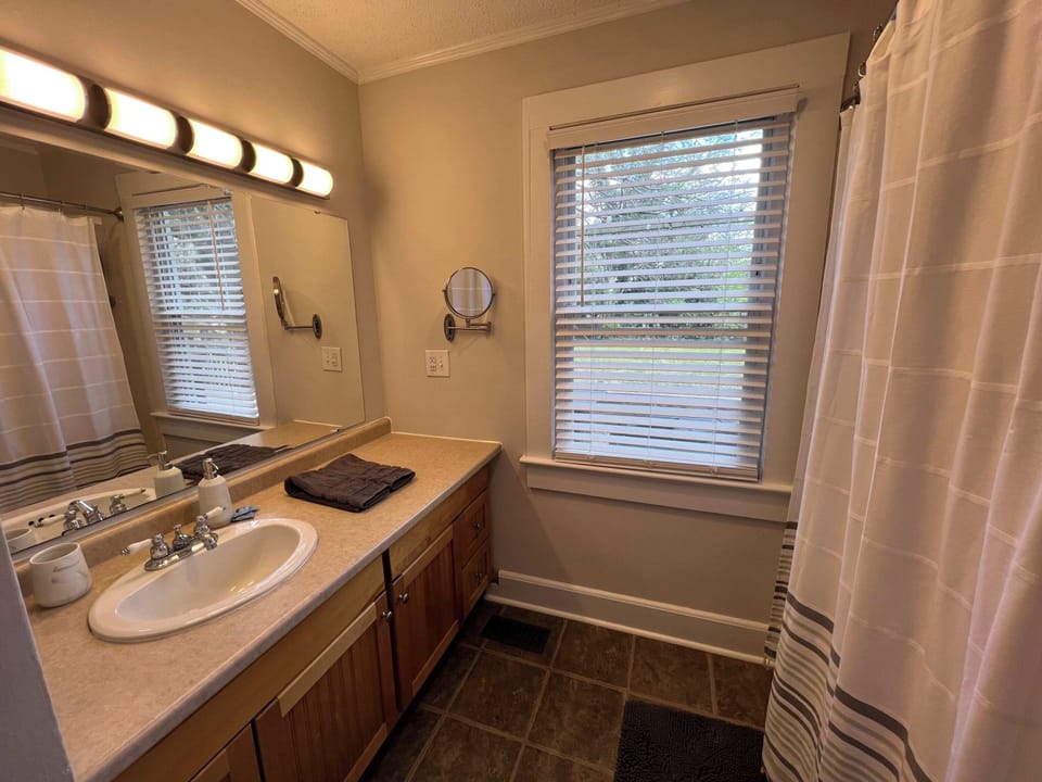 View of the full bathroom with tub shower