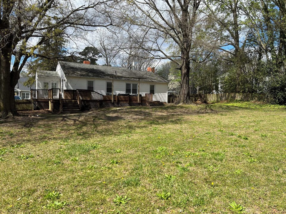 View of the back of the house and fenced in yard