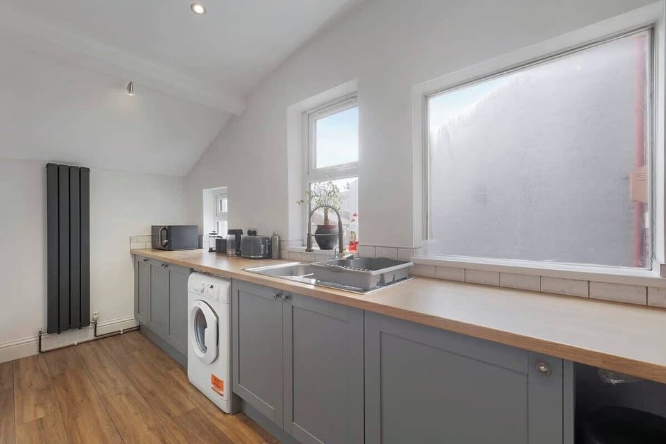 Kitchen equipped with all essentials, including a washer & dryer, oven, fridge and full cookware set.