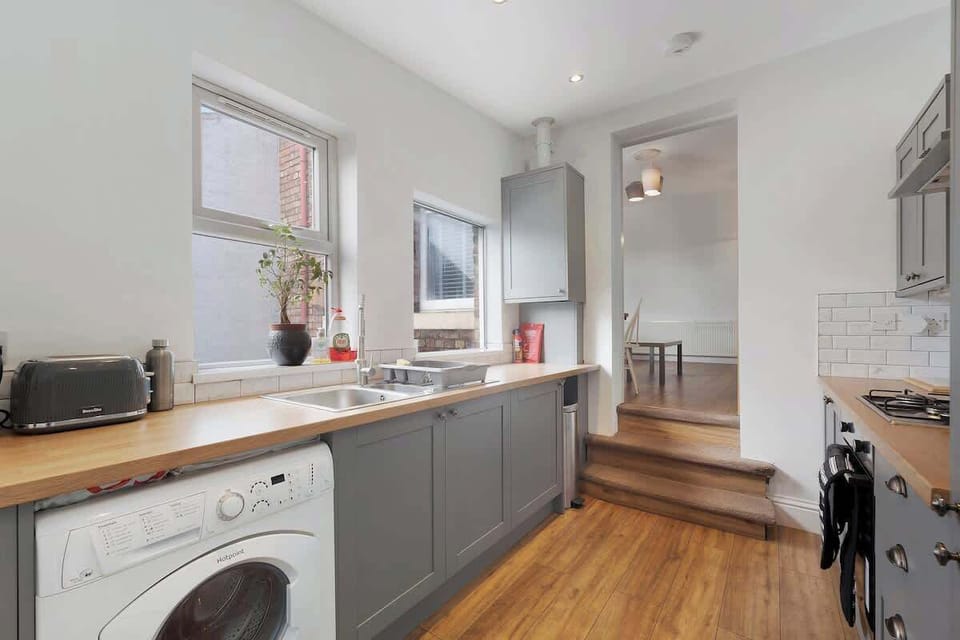 Kitchen equipped with all essentials, including a washer & dryer, oven, fridge and full cookware set.
