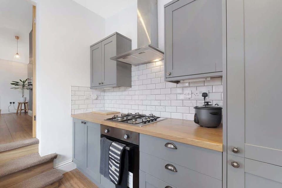 Kitchen equipped with all essentials, including a washer & dryer, oven, fridge and full cookware set.