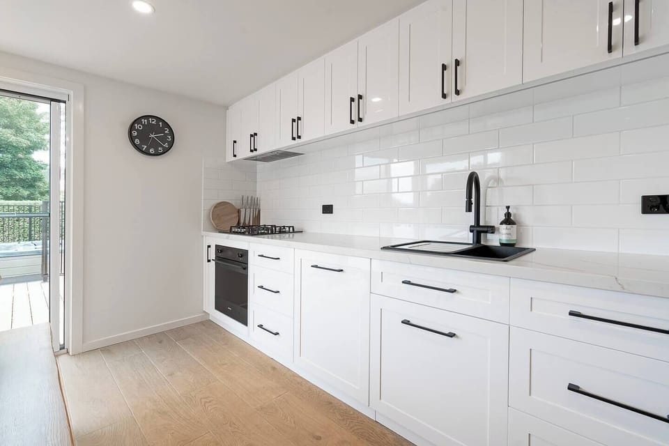 Prepare delicious meals in the fully equipped kitchen, complete with a gas stove, oven, dishwasher, and sleek black fittings. 