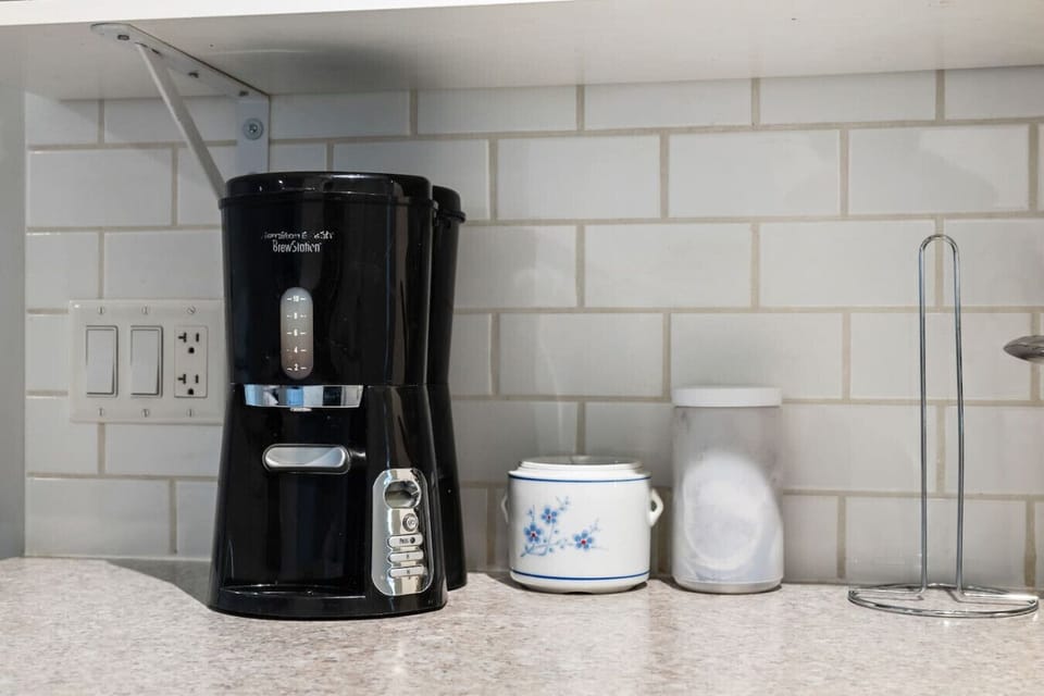 Full kitchen with a crockpot/slow cooker, drip coffee machine, ground coffee, tea and sugar. Please note there isn`t a dishwasher in this unit.