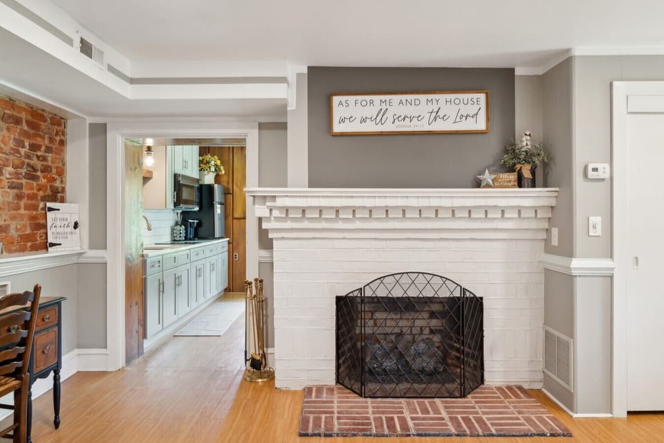 Decorative fireplace mantel adding charm between bedroom & kitchen