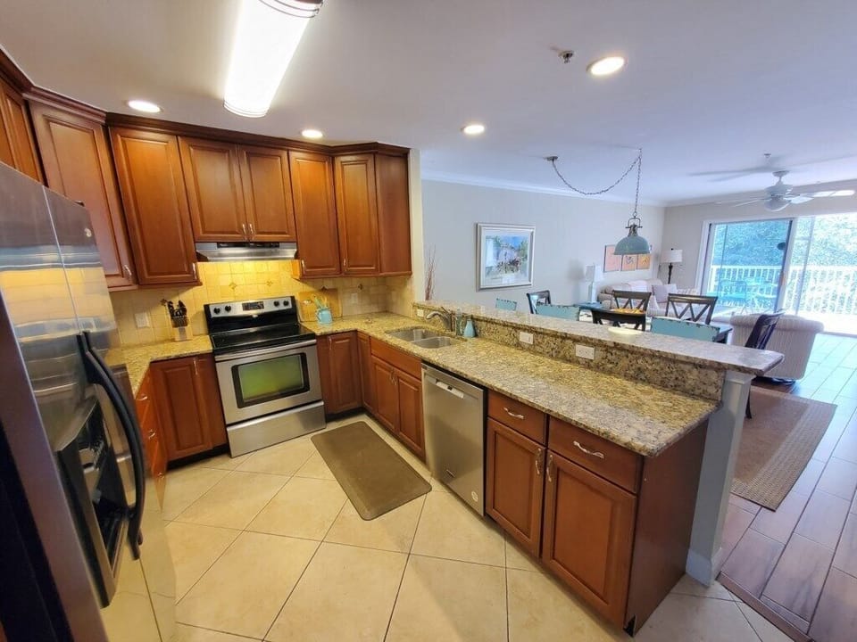 Fully-equipped kitchen with granite countertops and modern appliances.