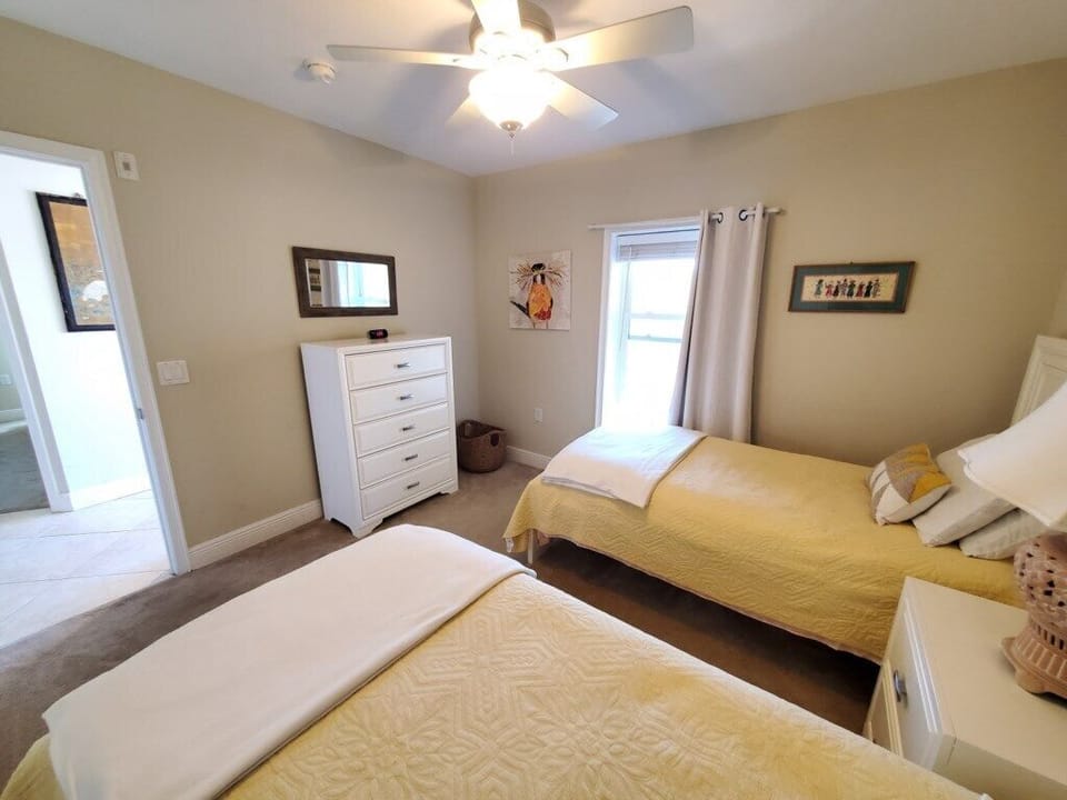 Inviting twin bedroom with ample natural light, perfect for relaxing.
