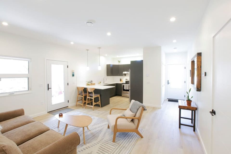 Open concept living/dining rooms with the front door on the right.