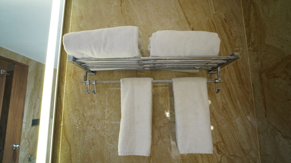Superior Triple Room, City View | Bathroom | Shower, hair dryer, slippers, towels