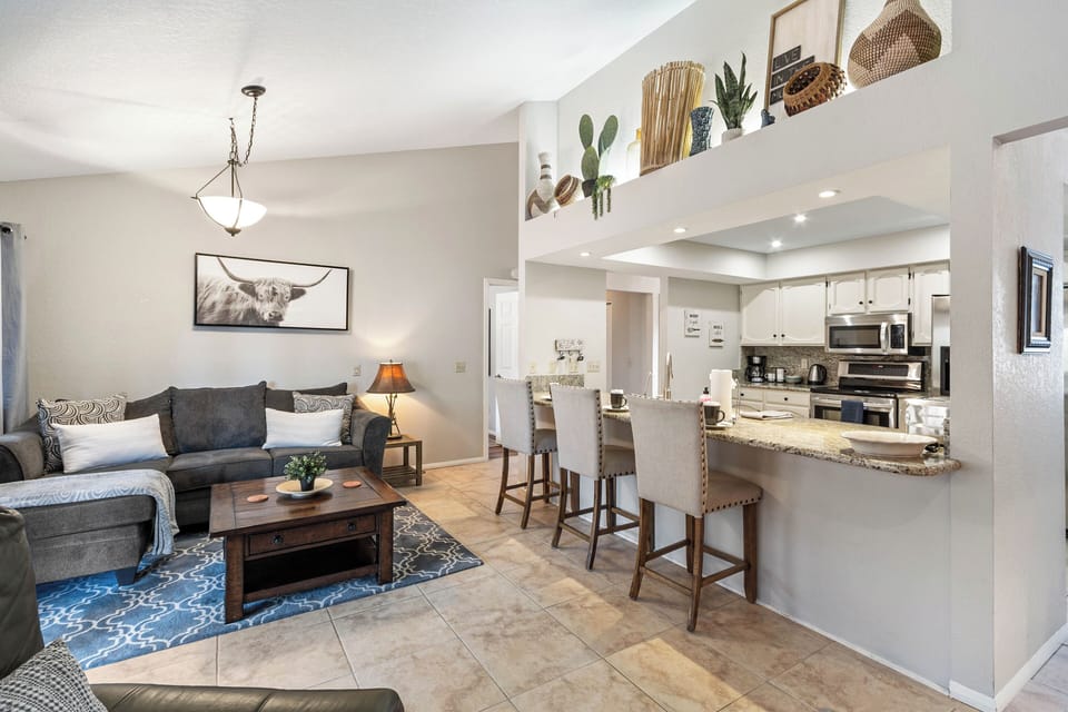 Island with seating for three (3), open concept to living room.