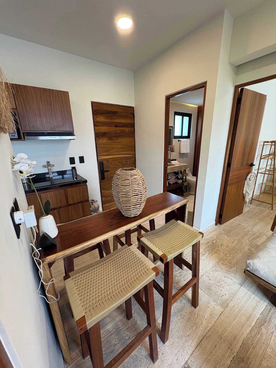 Dining Area 
Thoughtfully designed for both work and leisure, the dining area features a natural wood table and woven-fiber chairs that blend comfort with style. Whether you're starting your morning with fresh fruit and coffee or hosting a zoom call.