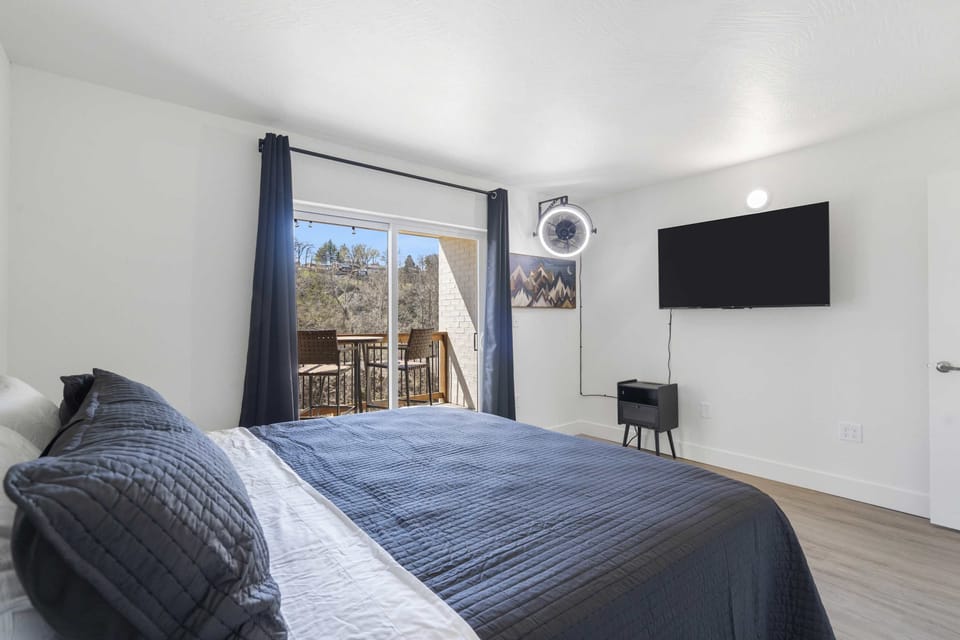 The elegant king bedroom includes a smart TV & balcony access