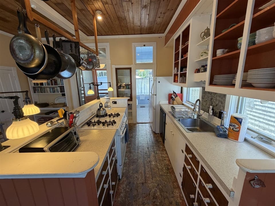 Kitchen looking to the 1st floor bathroom with claw foot tub-shower