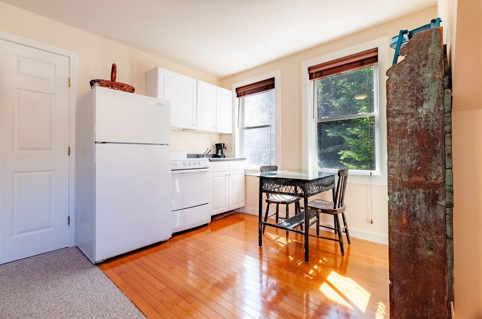 Kitchenette in garage apartment with coffee maker, fridge, stove and basic dishware