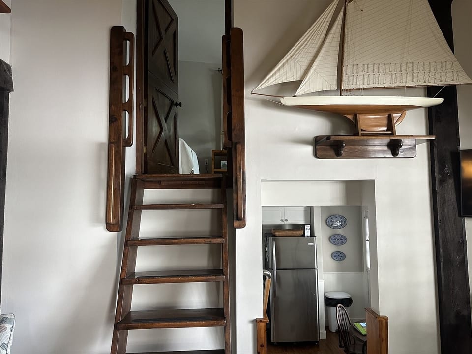 Living room and ladder steps to the twin bedroom loft